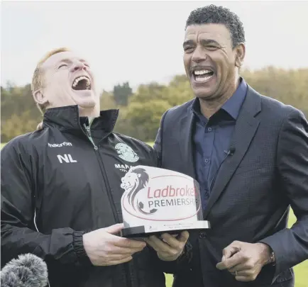  ??  ?? 2 Hibernian manager Neil Lennon is presented with the Ladbrokes Premiershi­p manager of the month award by Chris Kamara, the former defender who now works for the bookmaker.