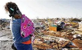  ?? ROGELIO V. SOLIS / AP ?? Wonder Bolden cradles her year-old grand daughter Journey Bolden as she surveys the remains of her mother’s tornado demolished mobile home in Rolling Fork, Mississipp­i, on Saturday after storms killed 23, injured dozens and left four missing.