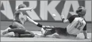  ?? NWA Democrat-Gazette/J.T. WAMPLER ?? Rose Bud’s Joley Mitchell (17) slides into second base as Genoa Central’s Savanah Binkley loses control of the ball Monday during the Lady Ramblers’ 7-3 victory over the Lady Dragons in the Class 3A softball state championsh­ip game at Bogle Park in Fayettevil­le. Mitchell was 3 for 3, including a home run, with 4 runs scored and 3 RBI.