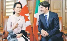  ?? — Reuters photo ?? Canada’s Prime Minister Justin Trudeau listens to Suu Kyi speak during a meeting in Trudeau’s office on Parliament Hill in Ottawa in this file picture.