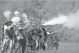  ?? FILE PHOTO ?? Reenactors from the American army fire a round at the British during the re-enactment of the Battle of Monmouth at Monmouth Battlefiel­d State Park, near where four industrial buildings could be built.