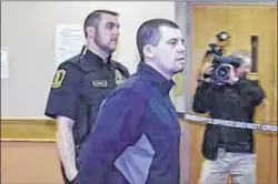  ?? FILE PHOTO ?? Justin Michael Jordan (aka Hussey) is led past reporters on the way out of the courtroom at provincial court in St. John’s in a file photo.