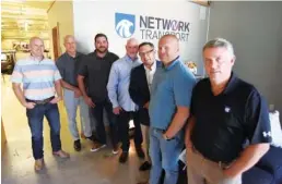  ?? STAFF PHOTOS BY MATT HAMILTON ?? Gathered at the office of Network Transport are, from left, Cole Isaacson, president of SOAR; Tim Patty, vice president of Network; Ben Gordon, vice president of Network; David Ferguson, president of Network; Bob Poulos, chief commercial officer; Cody Isaacson, CEO; and Marc Kramer, chairman.