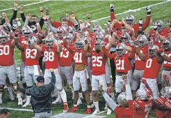  ?? ADAM CAIRNS/ THE COLUMBUS DISPATCH ?? Ohio State Buckeyes players do the Quick Cals drill before winning the Buckeyes’ 33rd Big Ten football championsh­ip.