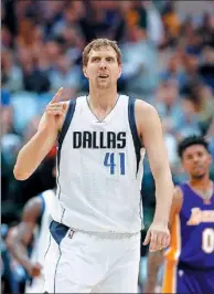  ?? TONY GUTIERREZ / AP ?? Dallas Mavericks forward Dirk Nowitzki of Germany celebrates sinking a 3-pointer early in Tuesday’s 122-111 victory over the LA Lakers in Dallas. Nowitzki reached the 30,000th career point milestone in the first half of the game.