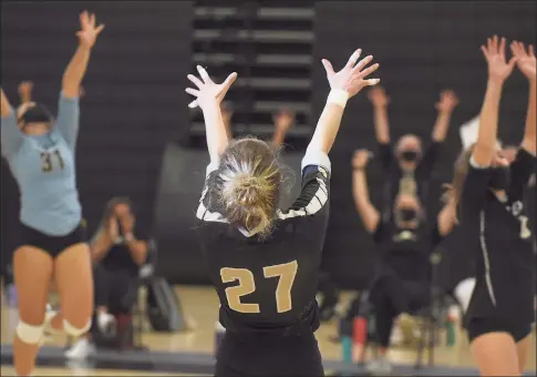  ?? Dave Stewart / Hearst Conncticut Media ?? The Trumbull Eagles, including Ali Castro ( 27), Kat Zanvettor ( 31) and Bailey Cenatiempo ( 6) celebrate a point during the FCIAC East Region girls volleyball final against Ludlowe in Trumbull on Saturday.