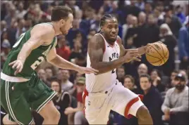  ?? The Canadian Press ?? Toronto Raptors forward Kawhi Leonard, right, moves around Boston Celtics forward Gordon Hayward during second-half NBA action in Toronto on Friday night.