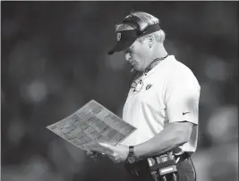  ?? ASSOCIATED PRESS ?? IN THIS SEPT. 10 FILE PHOTO, Oakland Raiders coach Jon Gruden looks at at charts during the second half of the team’s game against the Los Angeles Rams in Oakland, Calif. The winless Raiders play the Miami Dolphins, who have won twice, this week.Dallas (1-1) at Seattle (0-2)