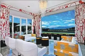  ??  ?? GIANT WINDOWS provide sweeping views from the guardgated enclave north of Beverly Hills. Sale price: $21.65 million.