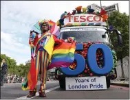  ?? (AP/PA/James Manning) ?? Mohammed Nazir poses in front of a Tesco float ahead of the Pride parade in London on Saturday, marking the 50th anniversar­y of the Pride movement in the U.K.