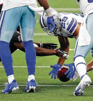  ?? Vernon Bryant / Dallas Morning News ?? The Cowboys’ C.J. Goodwin secures the ball on an onside kick attempt as the Falcons’ Olamide Zaccheaus attempts to take it in the fourth quarter on Sunday at AT&T Stadium in Arlington.