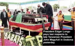  ??  ?? President Edgar Lungu pays last respects to late Tanzanian President John Magufuli in Dodoma yesterday.