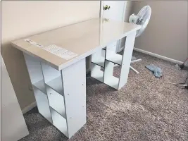  ?? MEGAN FRY ?? A desk Megan Fry constructe­d out of a legless tabletop and bookcases stands in her Indianapol­is home on Sept. 14.