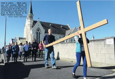  ?? PHOTO: DANIEL BIRCHFIELD ?? Faith in action . . . Mark Johnson and Jocelyn Marsh, of Oamaru, carry a wooden cross along Coquet St at the start of Good Friday’s walk of the cross from St Paul’s Church to St Luke’s Church in Oamaru.