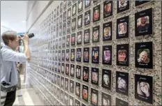  ?? AP file photo ?? A photojourn­alist takes pictures of the exhibits on “The Faces of Fentanyl” at DEA headquarte­rs before a press event at DEA headquarte­rs, Arlington, Va., in this file photo from Sept. 27. Heading into key elections, there have been assertions that the drug might be handed out like Halloween candy, something the U.S. Drug Enforcemen­t Agency’s head has said isn’t true. And some candidates for elected office frame the crisis as mostly a border-control issue, though experts say the key to reining in the crisis is reducing demand for the drugs.