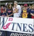  ?? DAVID DERMER — THE ASSOCIATED PRESS ?? Indians fans hold a sign before Friday’s game against the Kansas City Royals in Cleveland.