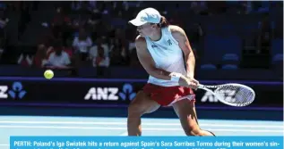  ?? — AFP ?? PERTH: Poland’s Iga Swiatek hits a return against Spain’s Sara Sorribes Tormo during their women’s singles match at the United Cup tennis tournament in Perth on January 1, 2024.