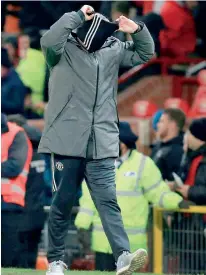  ?? ?? Manchester, United Kingdom: Manchester United's Portuguese manager Jose Mourinho removes his snood at the end of the English FA Cup third round football match between Manchester United and Derby County at Old Trafford in Manchester, North West England, on January 5, 2018. AFP