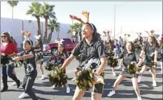  ?? WILLIAM ROLLER PHOTOS ?? ABOVE LEFT, FROM LEFT: Concepcion and Cliff Caldwell, who was the Grand Marshal of the 71st El Centro Christmas Parade that featured 116 entries on Saturday along Main and 12th streets to Bucklin Park. ABOVE RIGHT: The Imagine School drill team during...