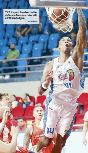  ?? JUN MENDOZA ?? TNT import Rondae HollisJeff­erson finishes a drive with a left-handed jam.