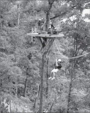  ?? Arkansas Democrat-Gazette/RICK McFARLAND ?? Theresa Simmons of Orange Grove, Texas, uses a zip line as part of the Buffalo River Canopy Tour. The line offers a quiet, bird’s-eye view of the forest, said Mike Mills, who opened the zip line in 2010.