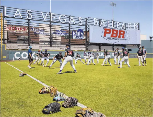  ?? L.E. Baskow Las Vegas Review-Journal @Left_Eye_Images ?? Players attending the Prep Baseball Report showcase Saturday at the Las Vegas Ballpark stretch in the summer sun.