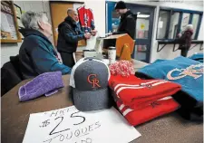  ?? ?? Rangers swag on sale before a game against the Grimsby Peach Kings. The team has always counted heavily upon volunteers to help run game nights and generate income, further tightening the bond between neighbourh­ood and team.
