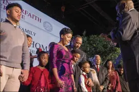  ?? POINTER / ALYSSA.POINTER@AJC.COM ALYSSA ?? Keisha Lance Bottoms and her family are prayed over during the inaugural interfaith worship service at Impact Church in East Point on Tuesday. Bottoms, who was later sworn in as Atlanta’s 60th mayor, promised to do “what is right and what is just.”