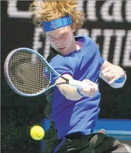  ?? Ng Han Guan Associated Press ?? ANDREY RUBLEV plays a forehand return to Dominic Thiem, who is on the road back after injuries curtailed his 2021 season and was given a wild-card entry.