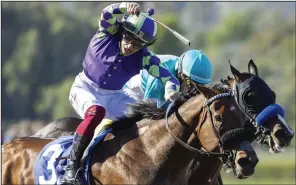  ?? (AP/Benoit Photo) ?? Stronghold (front), with jockey Antonio Fresu aboard, overpowere­d Imaginatio­n to win the Grade I Santa Anita Derby on Saturday in Arcadia, Calif.