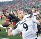  ?? DARRON CUMMINGS/AP ?? Desmond Ridder throws a football into the part of the stands occupied by Bearcats fans after Cincinnati defeated Notre Dame on Saturday.