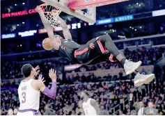  ??  ?? Serge Ibaka (top) of the Toronto Raptors dunks in front of Josh Hart (left) of the Los Angeles Lakers during the first half at Staples Center in Los Angeles. — AFP photo