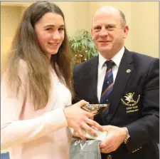  ??  ?? Becky Doyle is presented with the U-15 Girls Stroke Play trophy by Captain Denis Taylor.