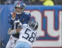  ?? SETH WENIG - THE ASSOCIATED PRESS ?? Tennessee Titans linebacker Harold Landry (58) applies a hit on New York Giants quarterbac­k Eli Manning (10) after releasing a pass during the first half of an NFL football game, Sunday, Dec. 16, 2018, in East Rutherford, N.J.