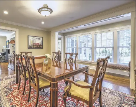  ?? Press/Cuozzo Realtors ?? The elegant living room and dining room at 129 Davis Street in Hamden with built-in buffet perfect for entertaini­ng.