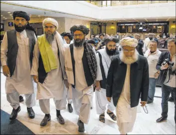  ?? Alexander Zemlianich­enko The Associated Press file ?? Members of the Taliban delegation arrive for talks in May in Moscow. The Taliban has pledged to keep terror groups from using Afghanista­n as a launching pad.