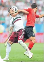  ??  ?? Mexico’s Carlos Salcedo (left) in a clinch with South Korea’s Hwang Hee-chan