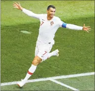  ?? Victor Caivano / Associated Press ?? Portugal’s Cristiano Ronaldo celebrates after scoring the opening goal during the group B match against Morocco on Wednesday.