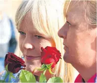  ?? Pictures: Gareth Jennings. ?? Left: Walkers set out at the start of the event in Dundee; and, above, some people threw roses into the River Tay as a memorial to those who have lost their lives to substance misuse.