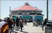  ?? Raul Roa Times Community News ?? A LINE for takeout formed Friday at Ruby’s Diner on the Huntington Beach Pier, which opened in 1996.