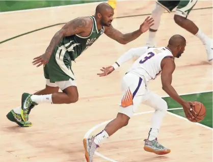  ?? MARK HOFFMAN / MILWAUKEE JOURNAL SENTINEL ?? P.J. Tucker and the rest of the Bucks defenders have a tough task in attempting to slow down Suns guard Chris Paul during the NBA Finals.