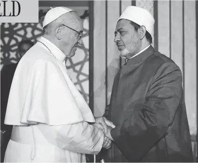  ?? AFP / AL-AZHAR MEDIA CENTRE ?? Pope Francis shakes hands with Sheikh Ahmed al-Tayeb, Grand Imam of Al-Azhar university, during a visit Friday in Cairo, where he rejected “every form of violence, vengeance and hatred carried out in the name of religion.”