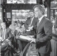  ?? — WP-Bloomberg photos ?? Phillipson reenacts some of President Kennedy’s most famous speeches while a friend, the Danish historian and author Pedersen, standing, looks on.