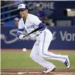  ?? NATHAN DENETTE/THE CANADIAN PRESS ?? The Blue Jays’ Ryan Goins lays down a sacrifice bunt against the Orioles Wednesday night.