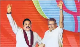  ??  ?? Mahinda Rajapaksa (left) and Gotabaya Rajapaksa wave to supporters during a party convention.
AP FILE