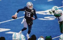  ?? Steve Conner / Associated Press 2020 ?? Nevada’s Carson Strong is pursued by Tulane’s Jeffery Johnson during the Famous Idaho Potato Bowl in December.