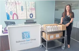  ??  ?? Sandra Hutton, manager of Balhousie Pitlochry care home, brings in some of the sanitiser delivered for the use of the residents and staff.