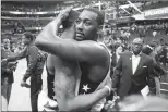  ?? Associated Press photo ?? Washington Wizards guards Bradley Beal, left, and John Wall embrace after Game 6 of the team's NBA second-round playoff series against the Boston Celtics, Friday, in Washington.