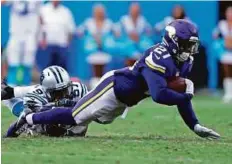  ?? AP ?? Vikings’ Jerick McKinnon (21) is tackled by Panthers’ Mario Addison in the second half their game in Charlotte on Sunday.