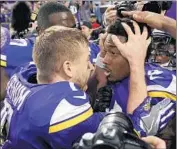  ?? Craig Lassig European Pressphoto Agency ?? CASE KEENUM celebrates his winning touchdown pass to Stefon Diggs, right, as teammates look on.